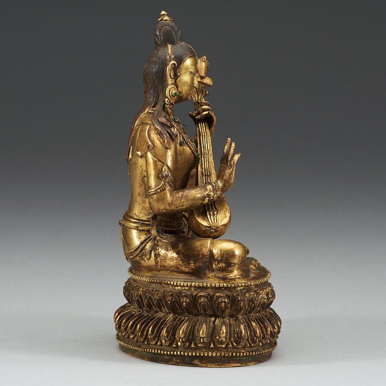 A Sinotibetan jeweled gilt bronze figure of Sarasvati, Qing dynasty, 19th Century.