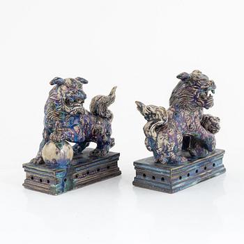 A pair of Chinese glazed stoneware buddhist lions, 20th century.