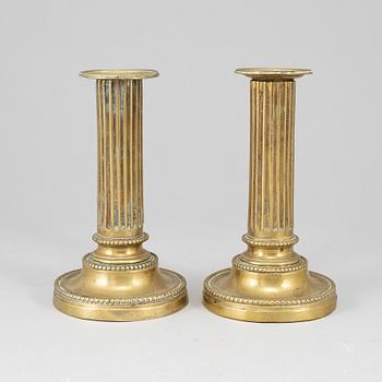 A pair of Louis Seize bronze candlesticks.