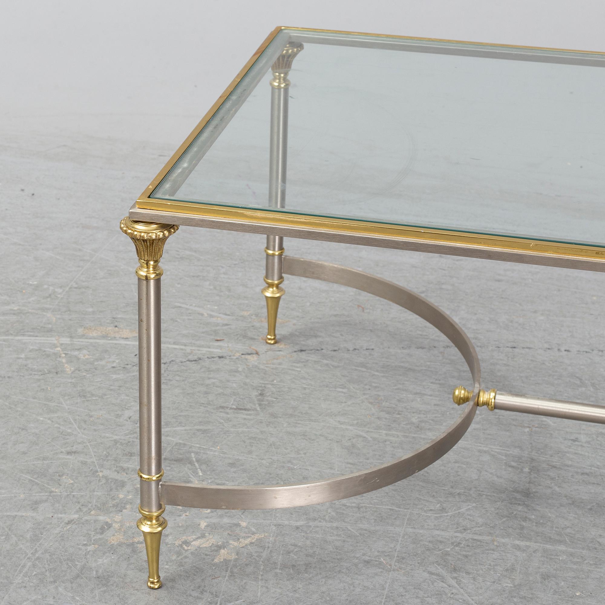 A 1970s sofa table, brass and glass.