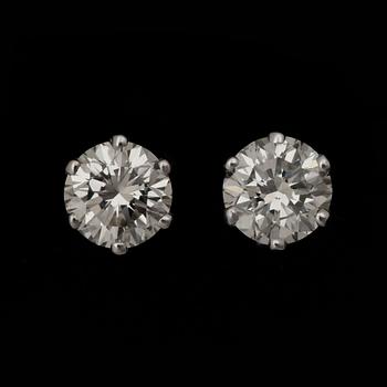 69. A pair of brilliant-cut diamond studs, total carat weight circa 2.04 cts.