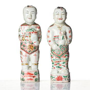 Three Chinese famille verte figures of laughing boys 'Hehe Erxian', 18th century.