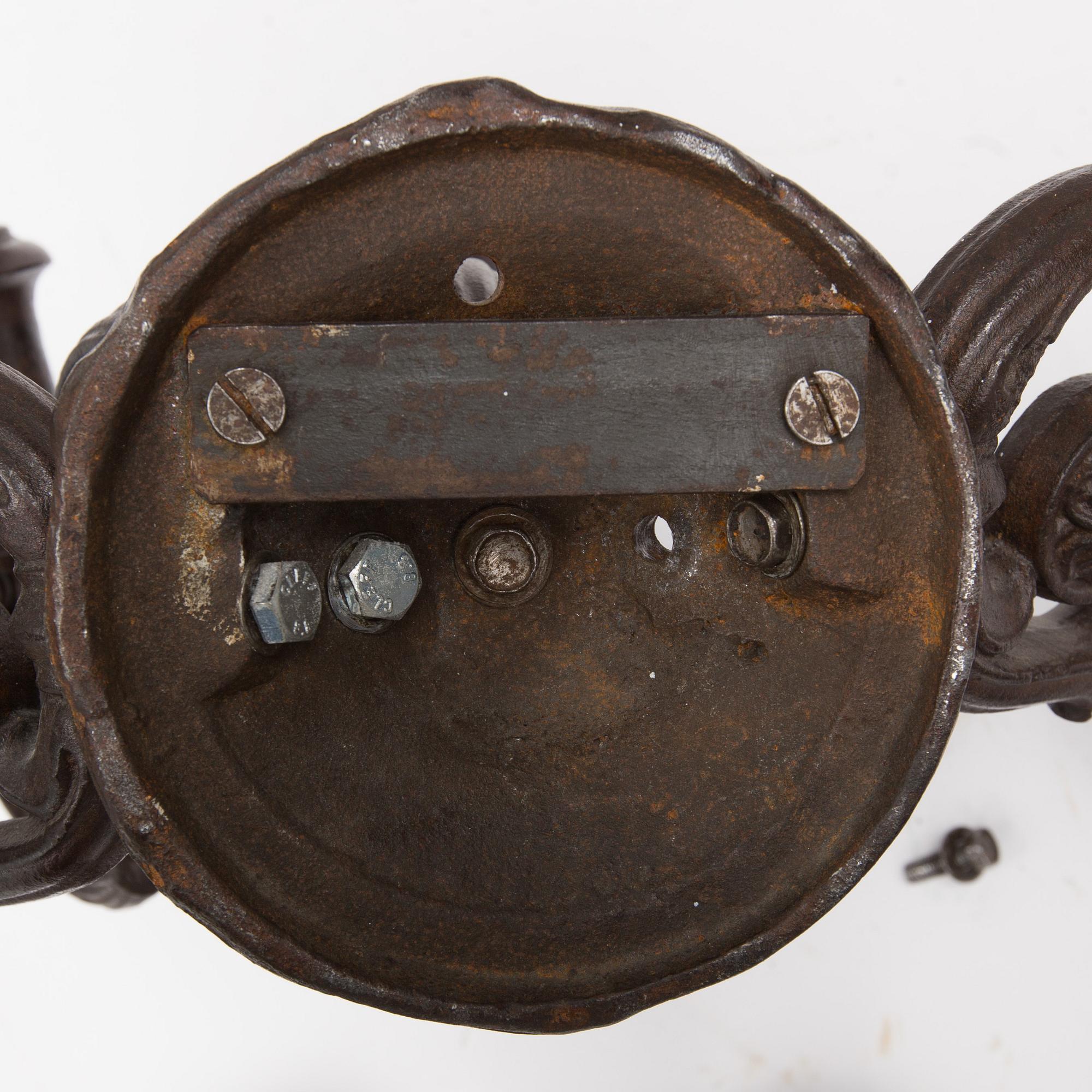 An early 20th century cast iron vall sconce candleholder for five candles.