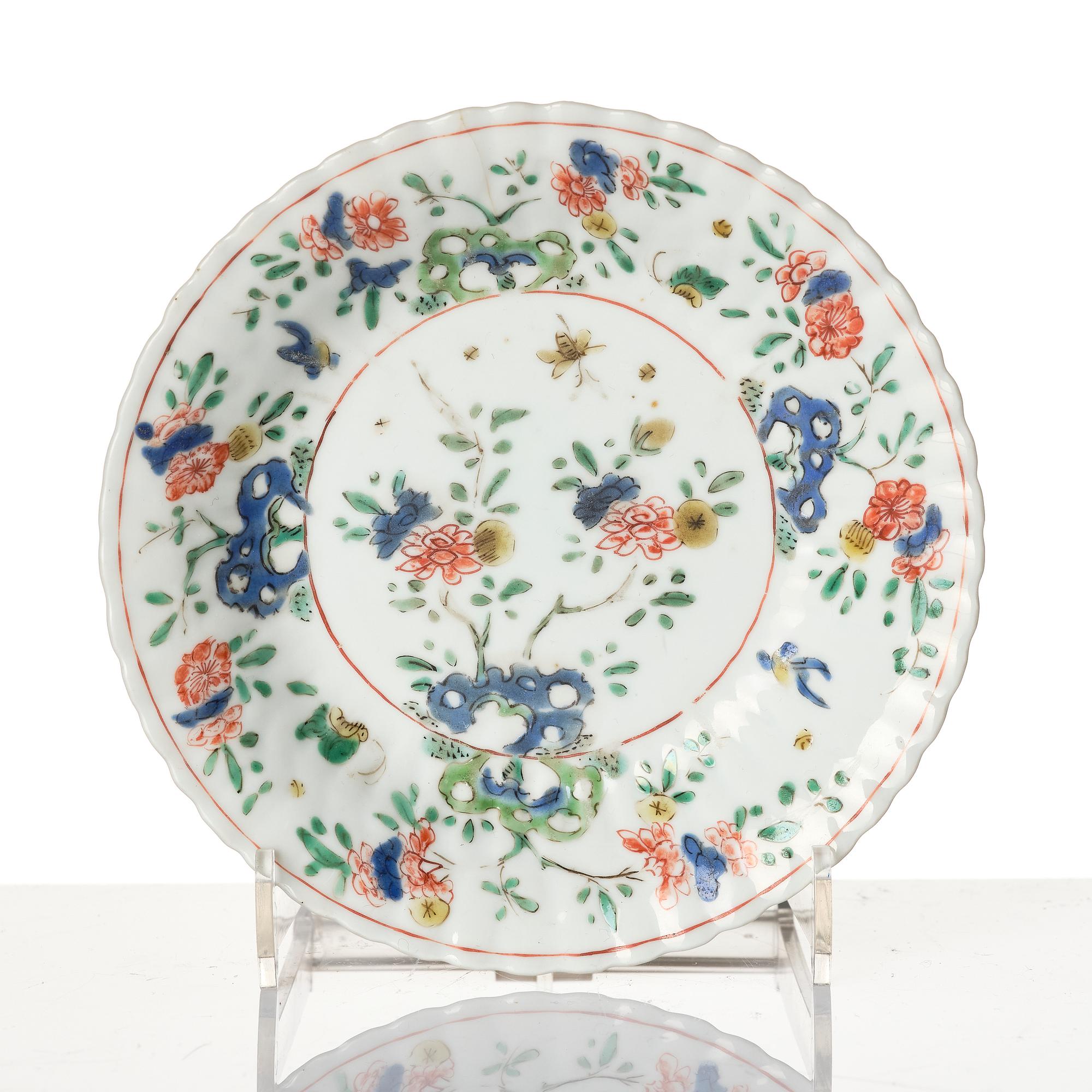 A Chinese iron red porcelain cup with saucer and a small famille verte dish, Qing dynasty, Kangxi (1662-1722).