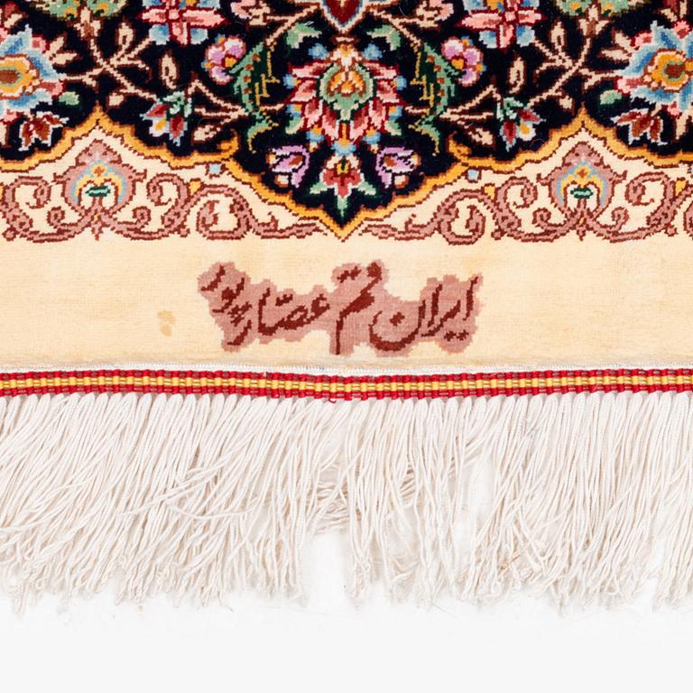 An extremely fine signed silk Qum rug, central Iran, c. 220 x 140 cm.