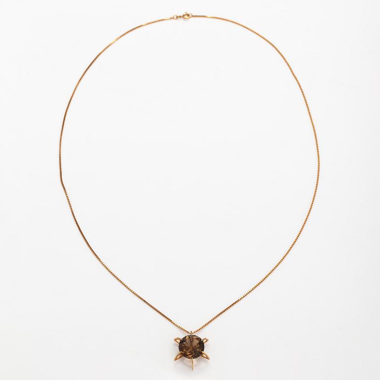 A 14K gold necklace with a smoky quartz. Martti Tapio Aarnio, Helsinki 1966.