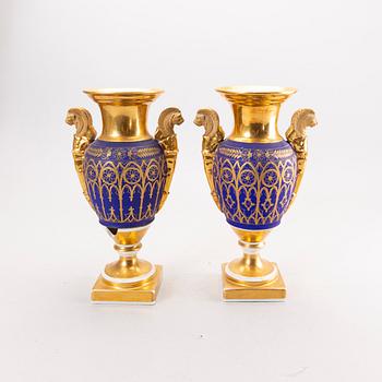 A pair of French Empire porcelain urns.