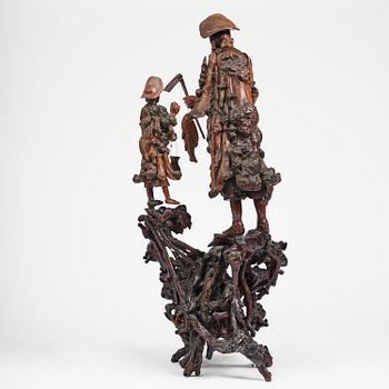 A large well sculptured root sculpture of 'Sholau and attendant', late Qing dynasty, 19th century.