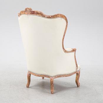 A gilt Louis XV style bergère, first half of the 20th Century.