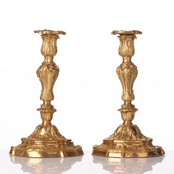 A pair of French Louis XV mid 18th century gilt bronze candlesticks.