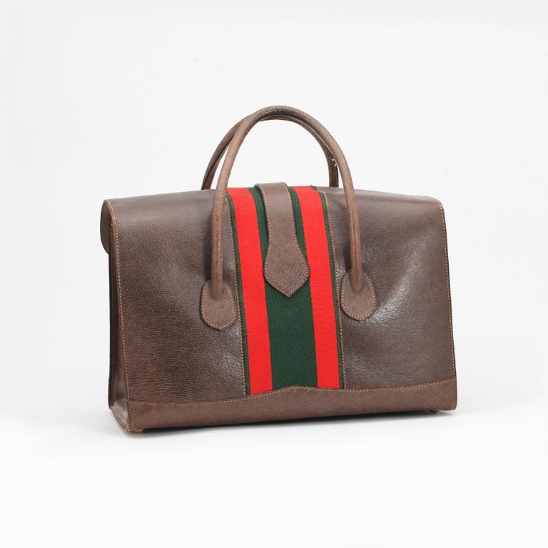 GUCCI, a brown leather bag and beauty box.