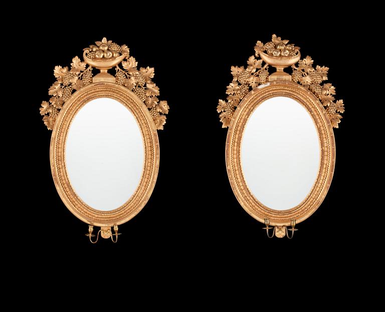 A pair of Swedish Empire 19th century two-light girandole mirrors.