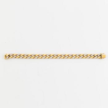 18K gold and brilliant cut diamond curb link bracelet.