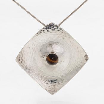 Elis Kauppi, a silver brooch/pendant, and tiger's eye. Kupittaan Kulta, Turku 1962.