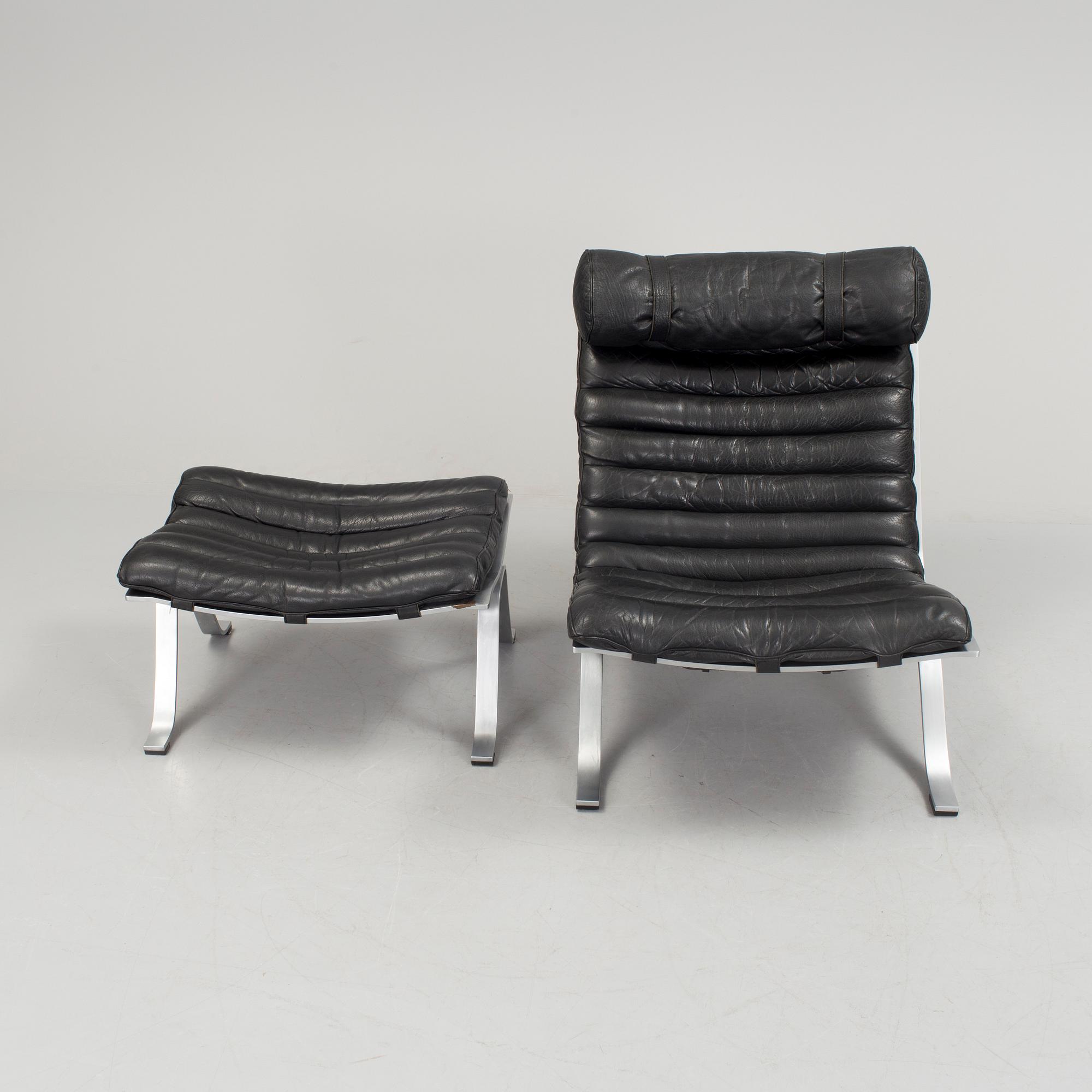 A black leather "Ari" easy chair with foot stool by Arne Norell for Norell möbler.