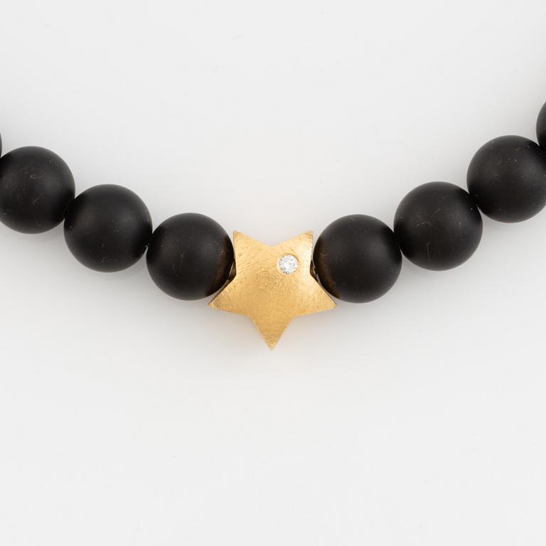 Ole Lynggaard, black stone  bead necklace, clasp star 18K gold with brilliant cut diamond.