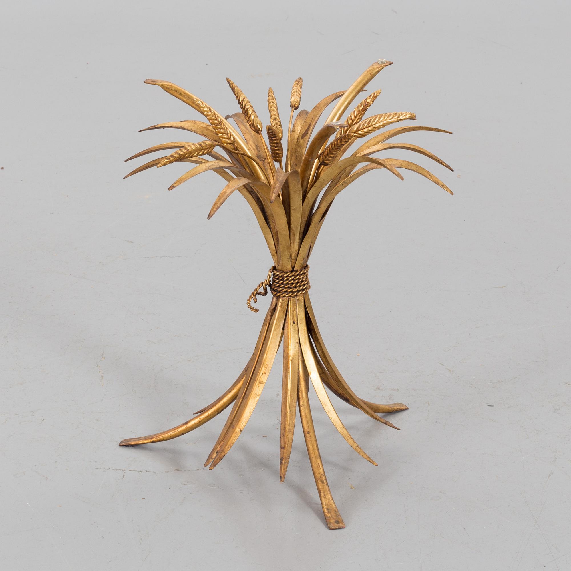 A HANS KÖGL ROUND GLAS AND GUILT METAL SMALL COFFEE TABLE.