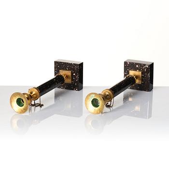 A pair of late Gustavian porphyry and gilt brass candlesticks, circa 1800.