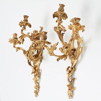 A pair of Louis XV mid 18th century three-light wall-lights.