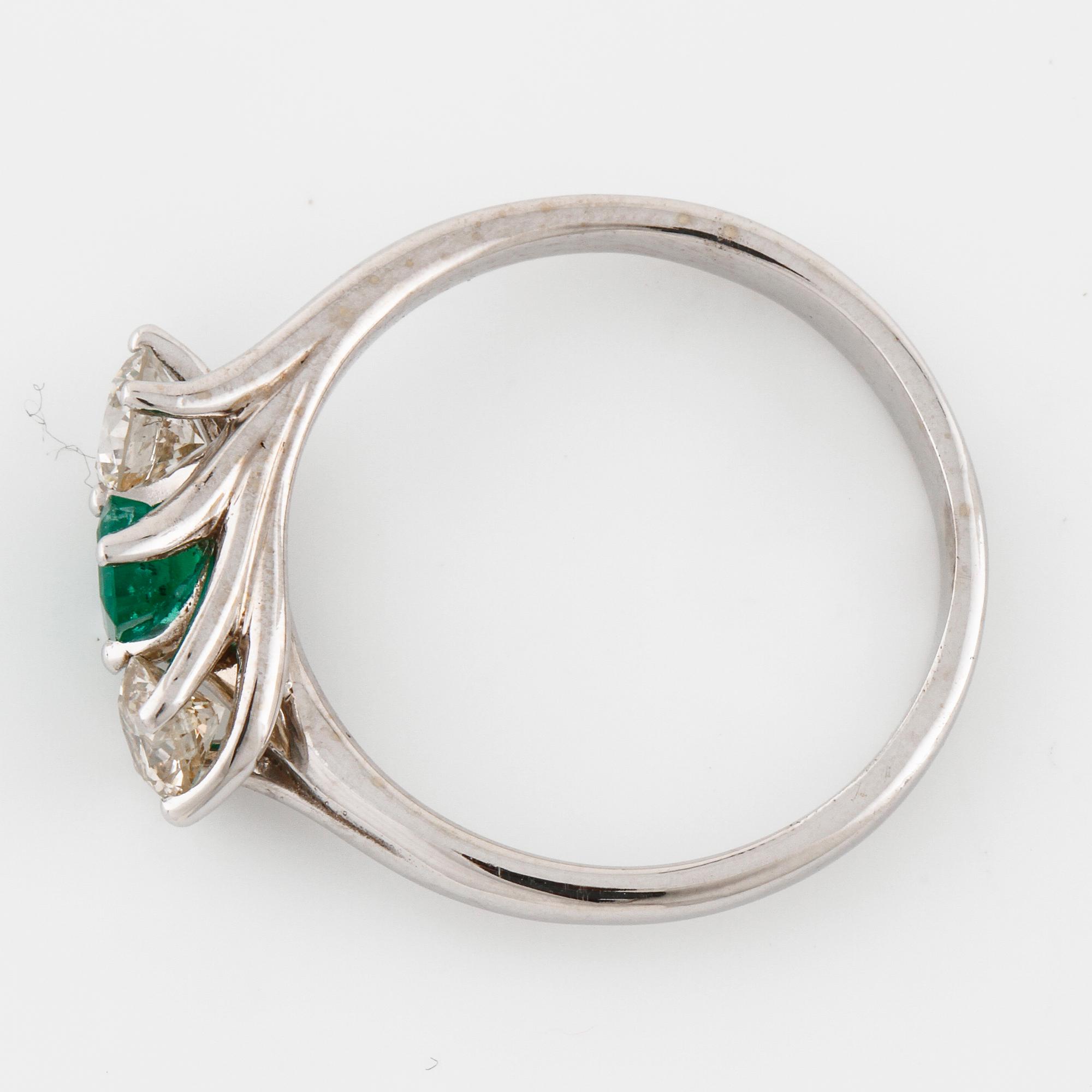 A emerald and brilliant cut diamond ring.