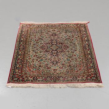 A silk Qum rug, around 114 x 80 cm.