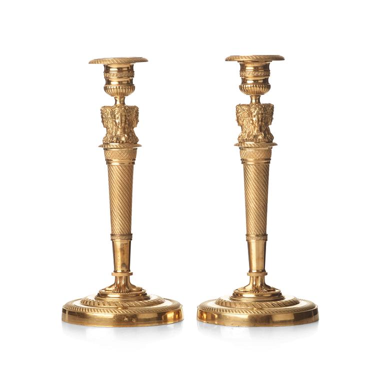 A pair of French Empire early 19th century gilt bronze candlesticks.