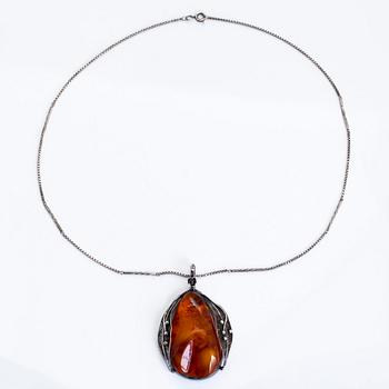 A silver and amber necklace, first half of the 20th century with later chain.