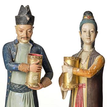 A pair of Chinoiserie figures of a Parsi tradesman and his wife, Qing dynasty, Canton, 19th century.
