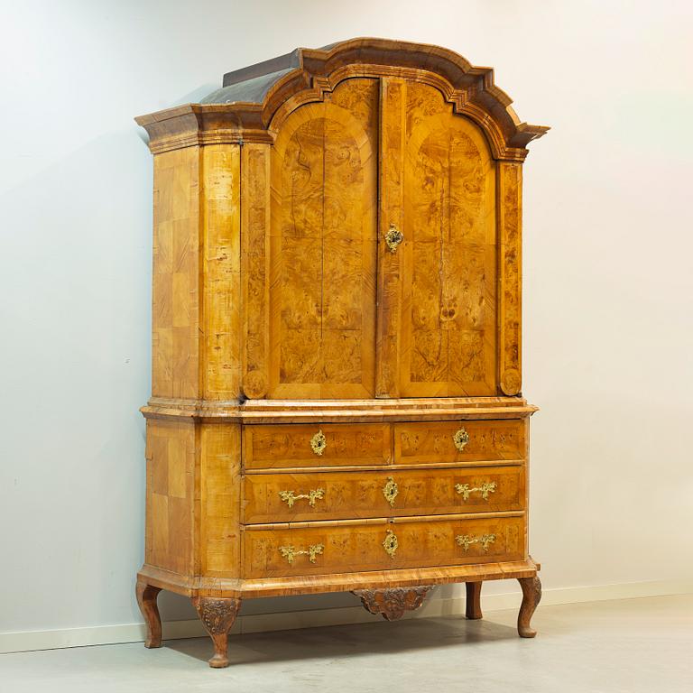 A Swedish elm and burr-elm rococo cabinet, later part of the 18th century.