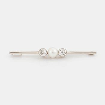 A 14K white gold brooch set with old-cut diamonds and a cultured pearl.