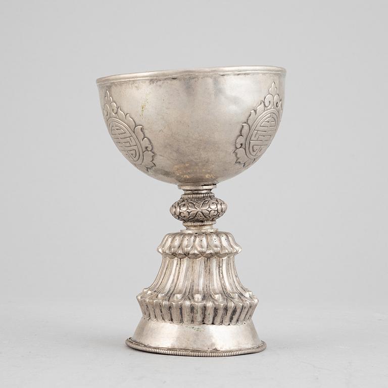 A Tibetan butter lamp, silvered copper, 20th century.