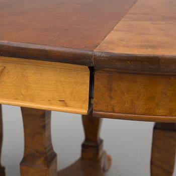 A first half of the 20th century dining table veneered with birch. With three extension leaves.