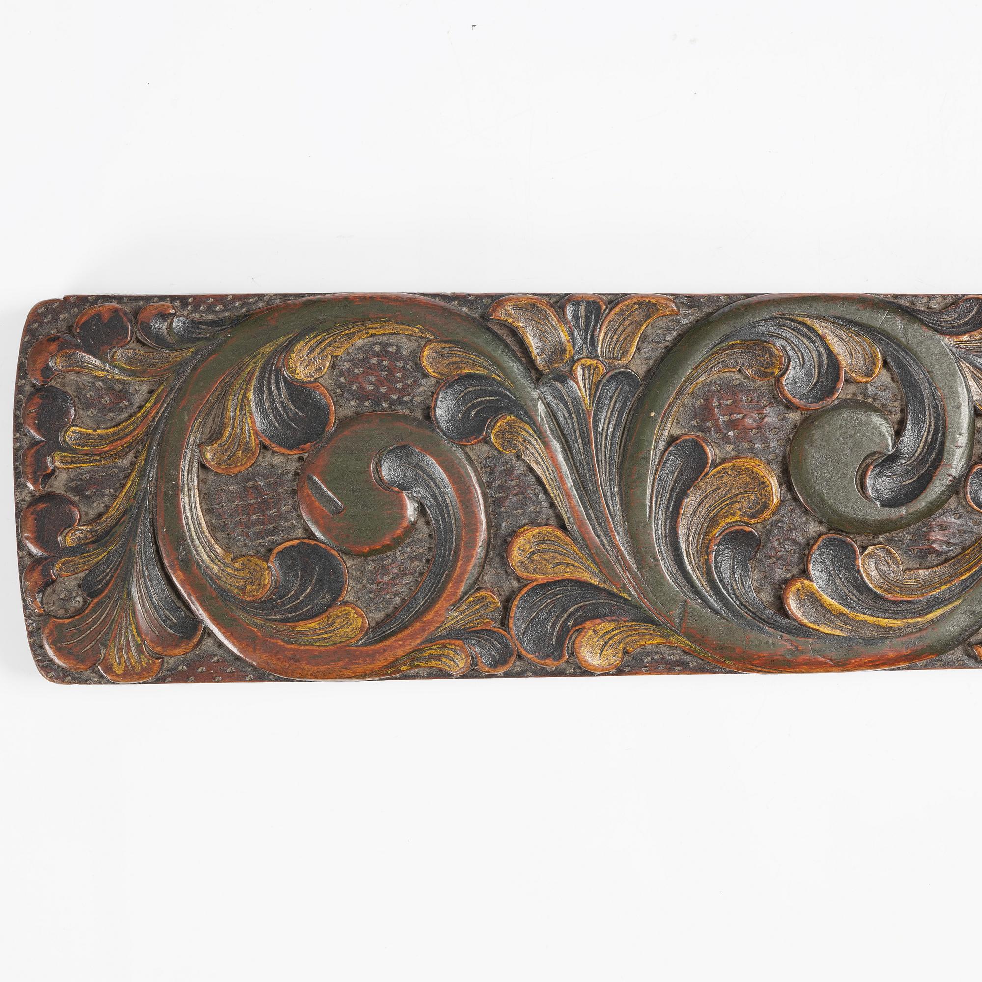 A carved and polychrome painted mangle board, Sweden, late 18th / early 19th century.