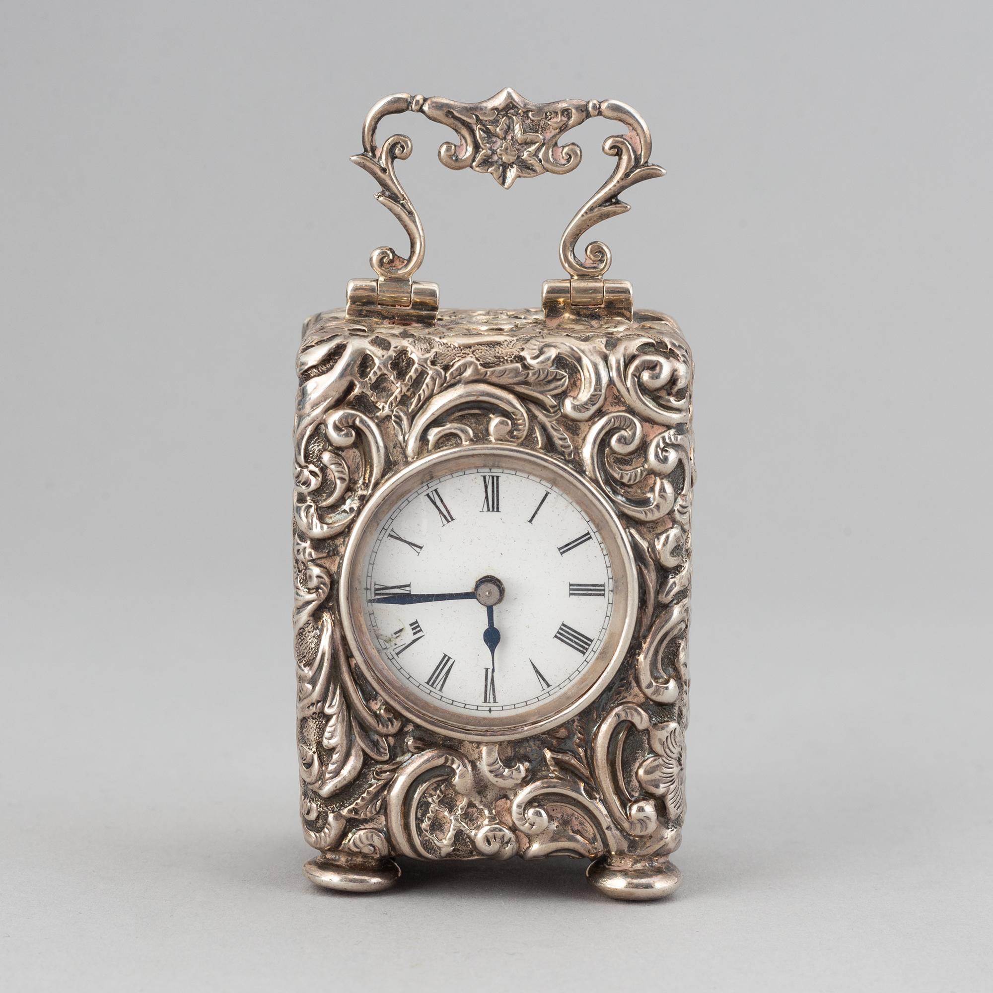 A rococo-style silver clock, mark of Henry Matthews, Chester 1903.