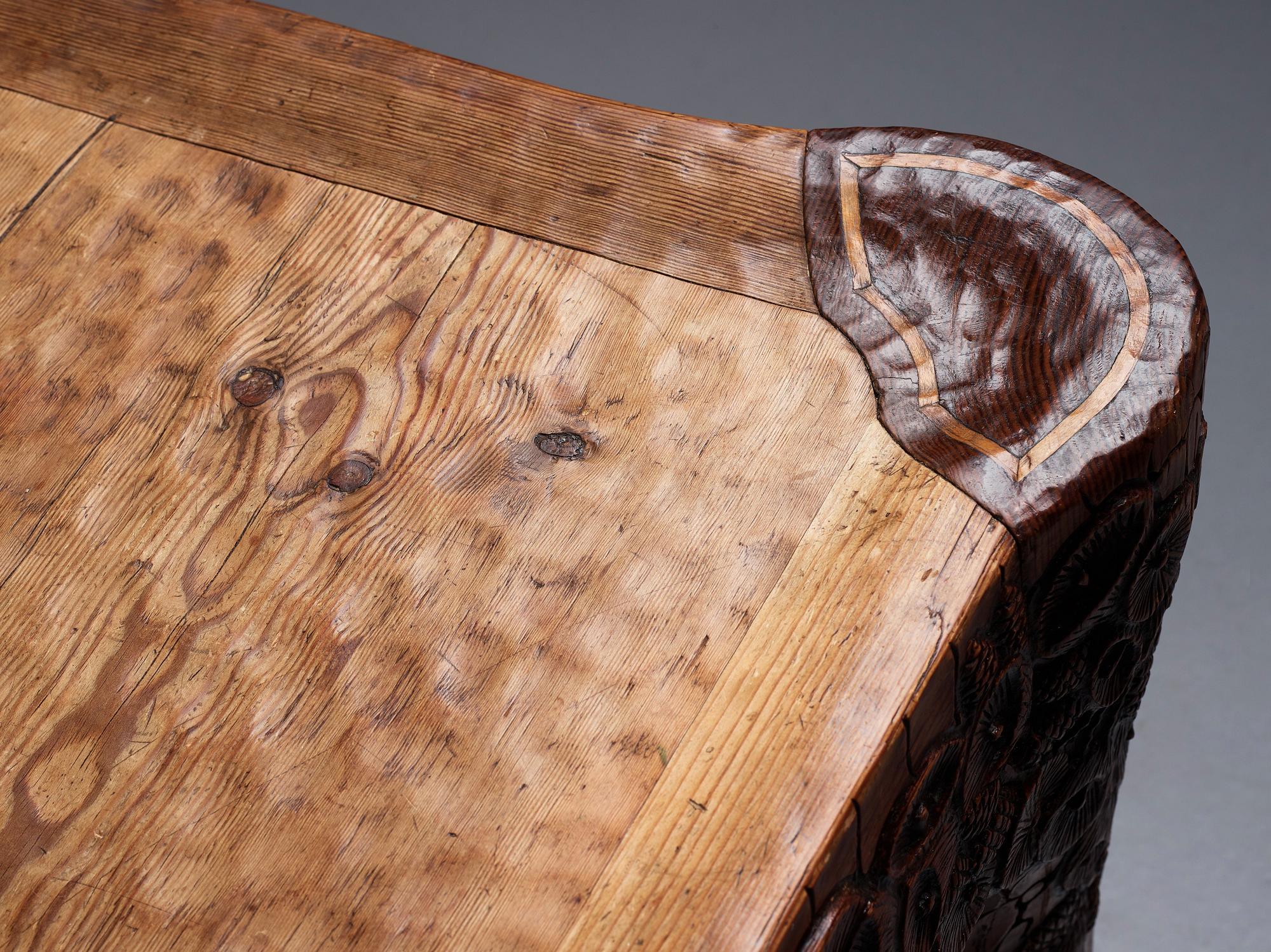 Gustaf Fjaestad, an Art Nouveau carved pine table, Arvika Sweden 1914, a double to the table in the Thiel Collection,