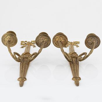 A pair of gilt brass wall sconces, Louis XVI-style, early 20th century.