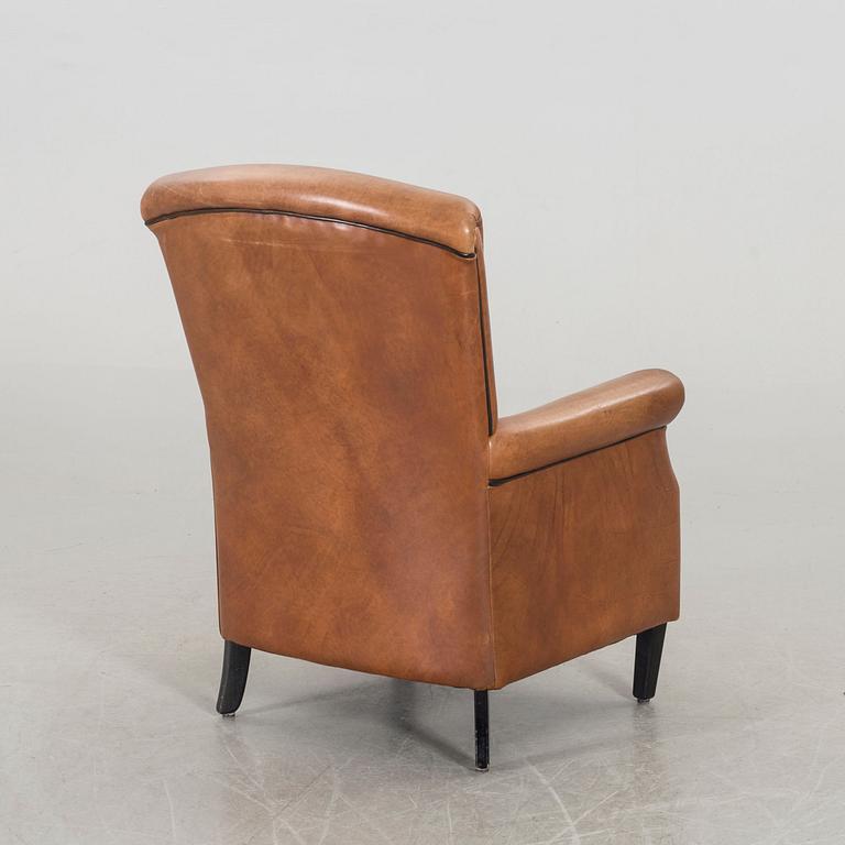 A LEATHER ARMCHAIR.