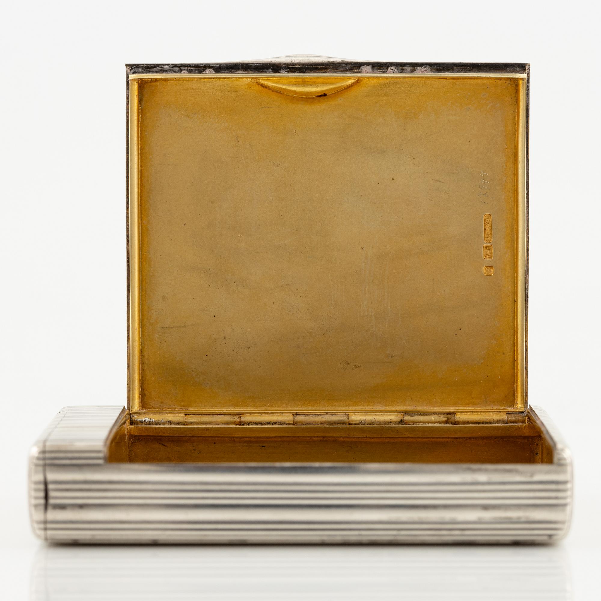 A Silver-gilt Fabergé Cigarette and Match Case, workmaster August Frederik Hollming, St. Petersburg 1908-1917.