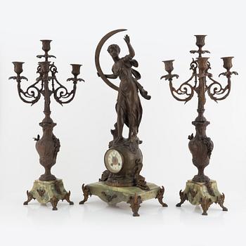 A mantel clock and pair of matching candelabra from the last quarter of the 19th century.