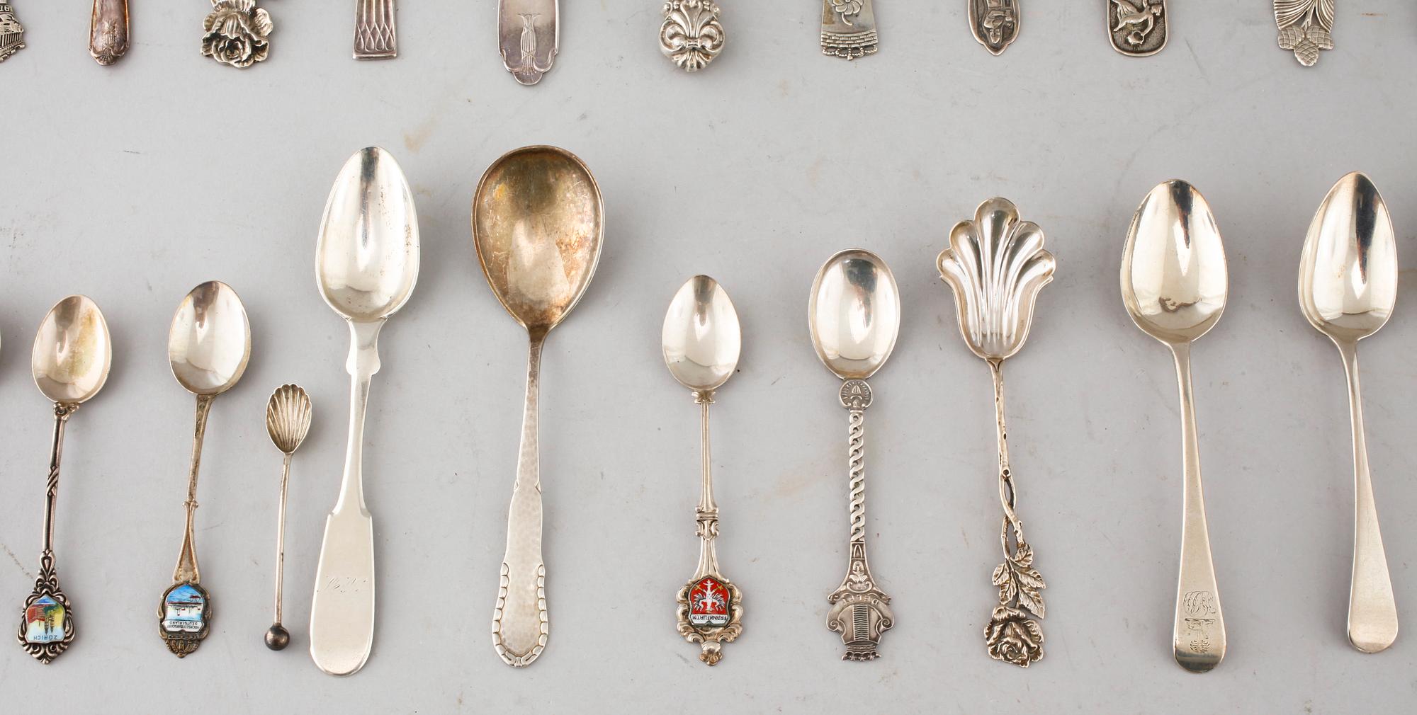 A collection of silver of 57 pcs, i.a souvenir spoons, 20th century. Total weight 1073 g.