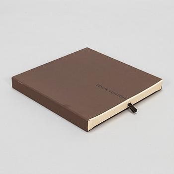 Louis Vuitton, a silk scarf.