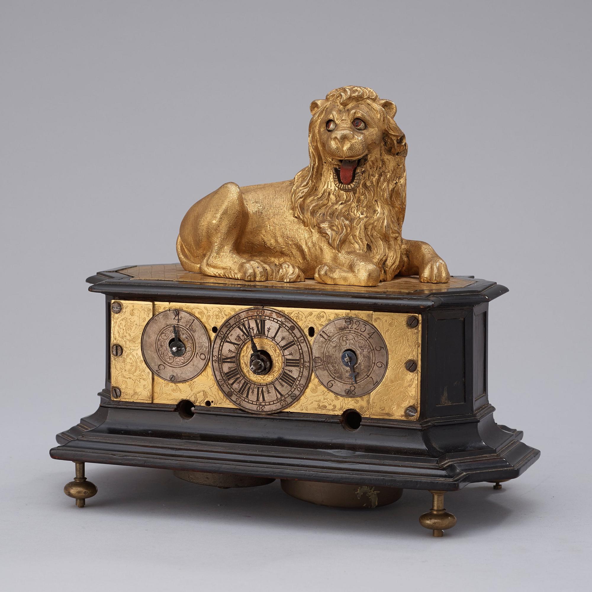 A rare gilt brass on ebonised base Lion Automaton figure clock, Augsburg circa 1630.