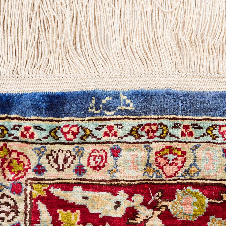An Oriental silk rug, signed, c. 125 x 85 cm.