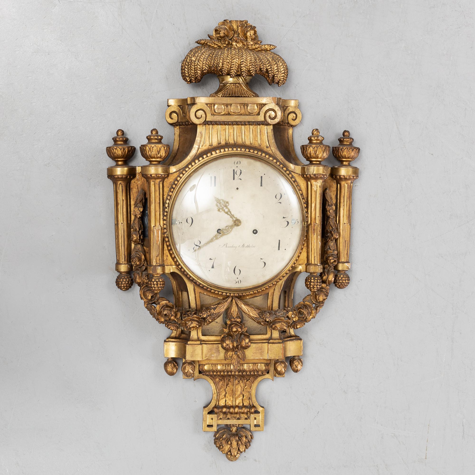 A Gustavian giltwood and parcel-gitl cartel clock by Per Henrik Beurling (Stockholm 1783-1806).