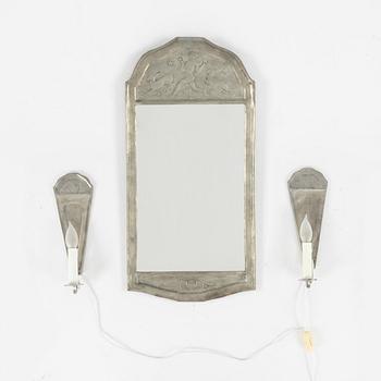 A pewter mirror with a pair of sconces, 1929.