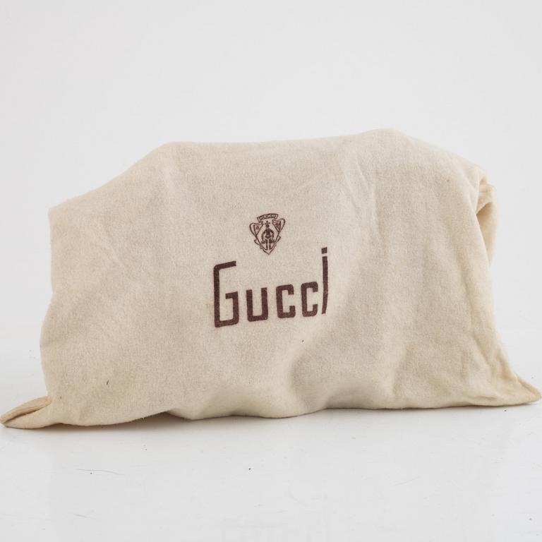 Gucci, a vintage suede bag.