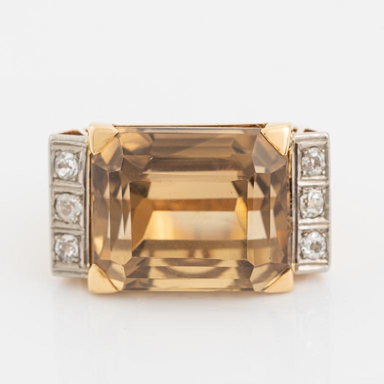 An 18K gold ring set with faceted quartz and old-cut diamons.