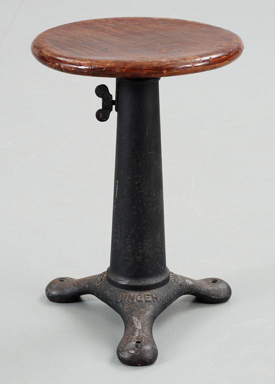An early 20th C cast iron 'Singer' stool with a turnable wooden seat.