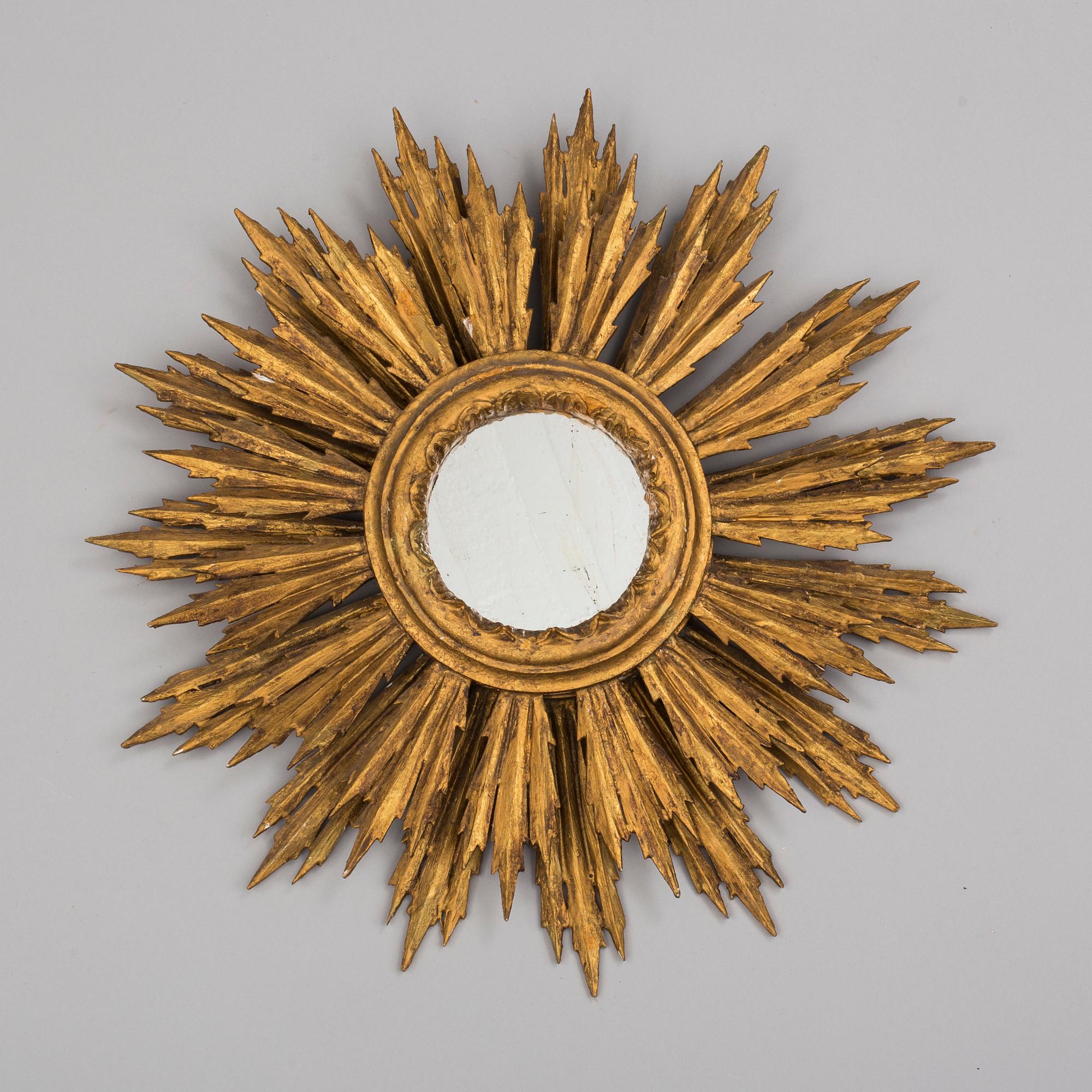 A first half of the 20th century sun mirror.