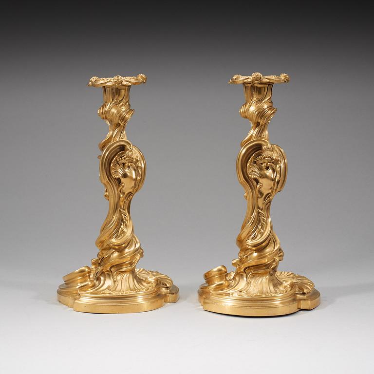 A pair of Louis XV 18th century gilt bronze candlesticks after the model by Juste-Aurèle Meissonnier.